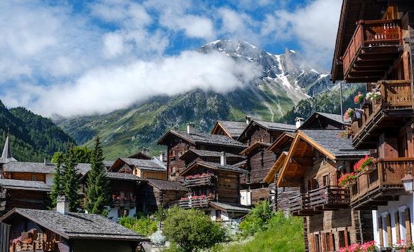 Traditional Swiss chalets with alpine backdrop